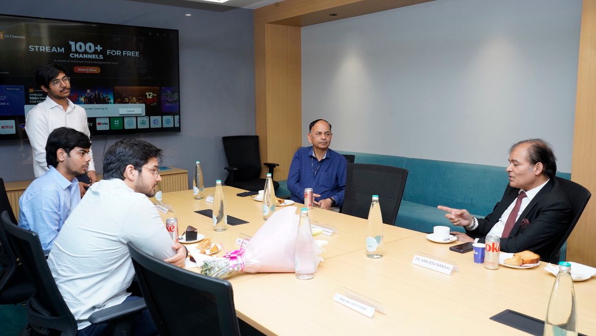 A boardroom session with a presentation on screen