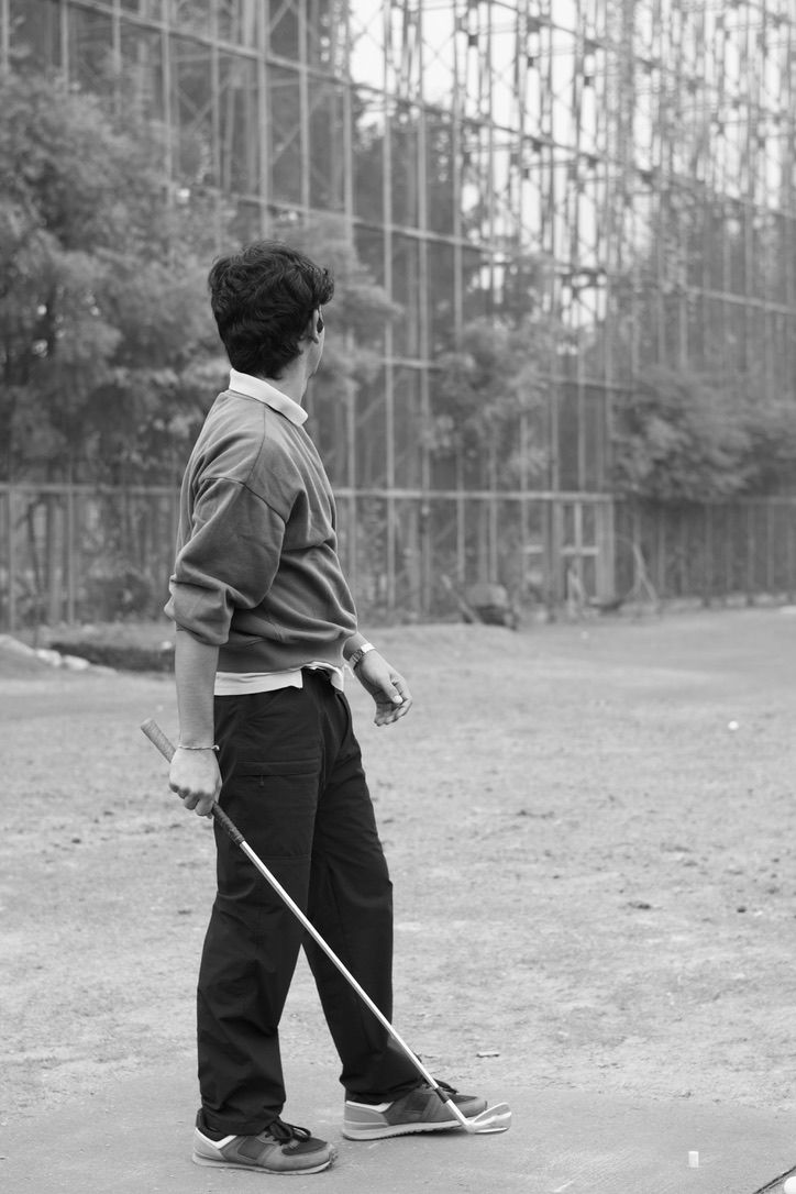 Holding a club at a driving range