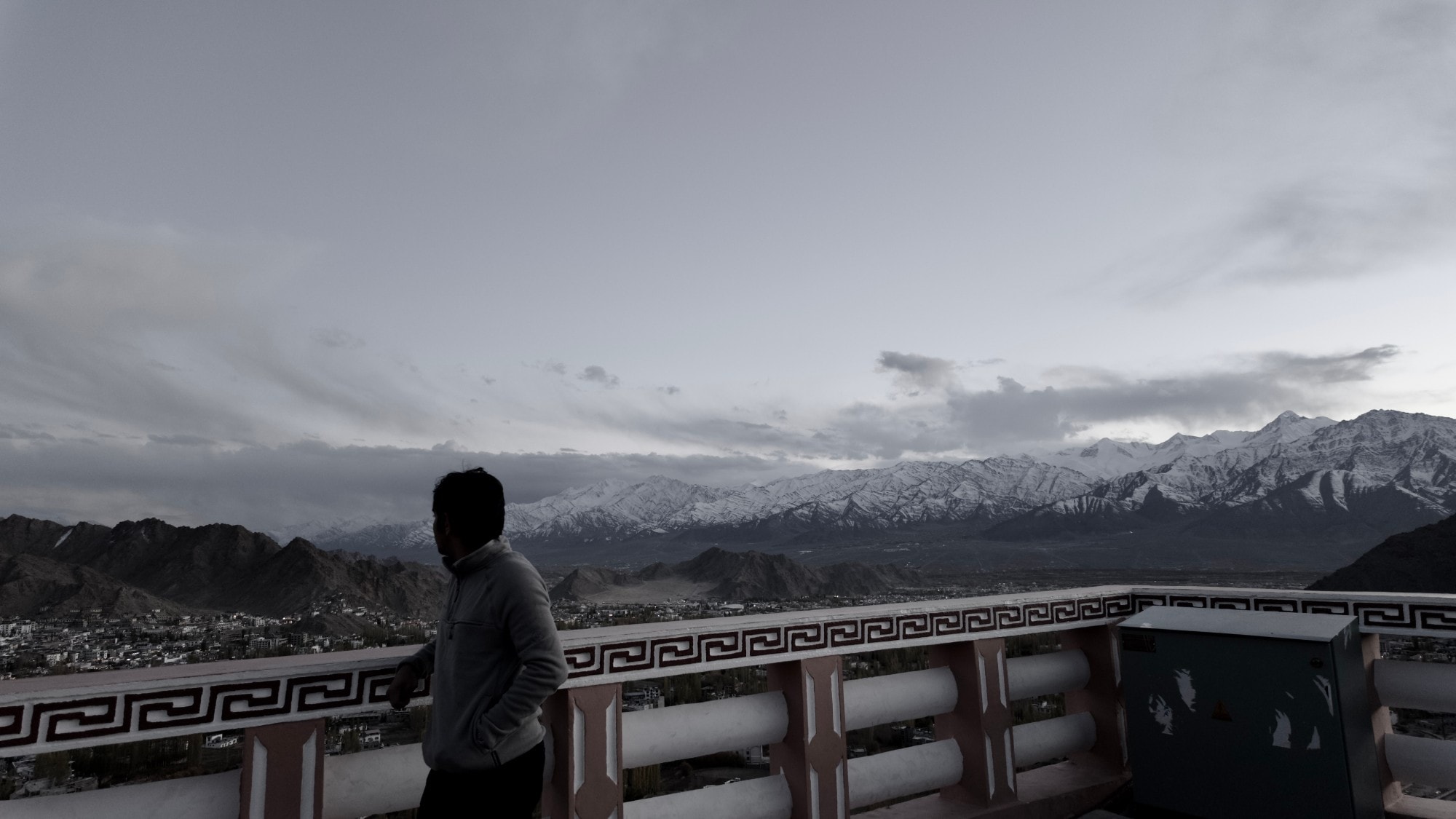 Snow-capped range seen from a terrace at dusk